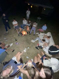 a group of people sitting around a fire pit