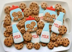 there are many cookies in the shape of teddy bears with milk bottles on them that say milk and milk