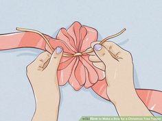 two hands tying a pink ribbon to a flower