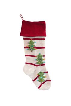 a white christmas stocking with red trimmings and green trees on the bottom