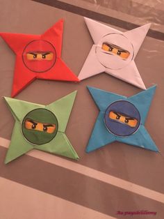 four star shaped origami with ninja faces on them