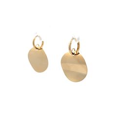 These modern earrings feature wavy medallions on small hoops. Finished in 14k yellow gold, the medallions have a wavy texture that allows light to shimmer and refract with every movement. The discs are attached to small hoops, allowing the lightweight earrings to move easily. These earrings are both very now and yet will be a timeless addition to any collection. Gold Hammered Round Huggie Earrings, Hammered Gold Round Huggie Earrings, Modern Yellow Gold Round Disc Jewelry, Modern Round Gold Plated Earrings, Yellow Gold Circle Earrings, Modern Yellow Gold Round Earrings, Yellow Gold Circle Brass Earrings, Yellow Gold Circle Earrings In Brass, Modern Gold Round Earrings