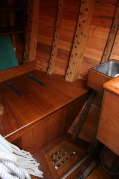 the inside of a boat with wooden walls and flooring