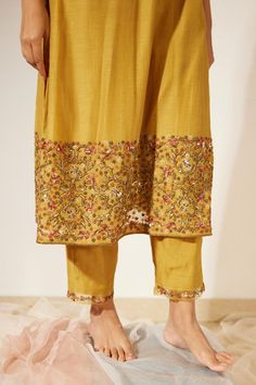 Yellow three fourth lantern sleeves chanderi silk straight kurta with sequins, thread and beads embroidered kurta and sleeves hem. Comes with matching straight pant.
Components: 2
Pattern: Embroidery
Type Of Work: Sequin, Thread, Beads
Neckline: V Neck
Sleeve Type: Three Fourth Sleeves
Fabric: Chanderi Silk
Color: Yellow
Other Details: 
Side slits
Model height: 5 ft 8 inches, wearing size L
Occasion: Puja, Sangeet - Aza Fashions Bollywood Tussar Silk Sets With Mirror Work, Mirror Work Slub Silk Palazzo Set For Festivals, Slub Silk Palazzo Set With Mirror Work For Festivals, Festive Straight Palazzo Set With Zari Work, Eid Tussar Silk Traditional Wear With Mirror Work, Long Sleeve Sharara With Mirror Work In Slub Silk, Festive Kurta With Zari Work And Straight Pants, Traditional Kurta With Dabka Work And Straight Pants, Long Sleeve Slub Silk Sharara With Mirror Work