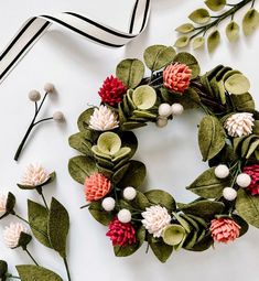 a wreath made out of fake flowers and leaves