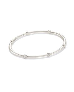 Elevate your arm party with this forever keepsake. Designed with bezel set White Diamonds around a solid 14k White Gold band, the Audrey Bangle Bracelet adds a sophisticated sparkle to any stack. 

 We have taken steps to ensure that, when applicable, our diamonds are conflict free by requiring our suppliers to comply with the Kimberley Process. White Gold Bangle, Arm Party, Gold Bangle Bracelet, Gold Bangle, White Gold Band, Diamond Sizes, Gold Band, White Diamonds, Gold Bangles