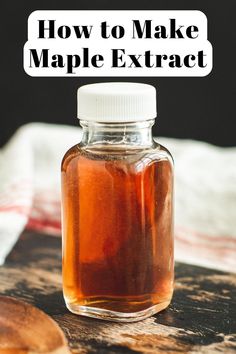 a jar filled with maple syrup sitting on top of a wooden table