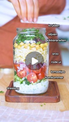 a mason jar filled with different types of salads and ingredients to make it into a salad