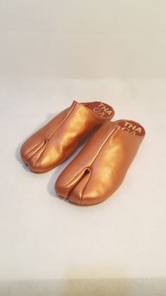 Beautiful handmade leather Japanese Tabi mules with split toe design, and fit like a glove. The tabis are made with soft supple leather and are very comfortable and will mold to your foot with time. Pre order: Please note these boots are made upon order and will take 4-6 weeks to complete and ship. Handmade with top quality materials and stacked leather soles. The shoes will have minor imperfections do to handmade handling and painting. Sizes: 7-11 or 37-42 Please contact me for any questions. Comfortable Leather Mules With Single Toe Strap, Brown Mules With Rubber Sole And Single Toe Strap, Brown Mules With Single Toe Strap And Rubber Sole, Ninja Shoes, Woven Mules, Pom Pom Sandals, Tabi Socks, Wedding Slippers, Tabi Shoes