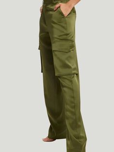 Elevate your style with the luxurious Good American Satin Cargo Pants. Crafted from a blend of 95% polyester and 5% elastane, these lightweight pants offer comfort and sophistication.Designed with a concealed button, hook-and-eye, and zip-fly fastening at the front, these cargo pants provide a secure and stylish fit. The regular fit, mid-rise silhouette features straight legs and a structured waistband with belt loops for added elegance.These versatile pants have two slip pockets at the front, t Satin Cargo Pants, Juniper Green, Cargo Outfit, Satin Texture, Cargo Pants Outfit, Versatile Pants, Lightweight Pants, Trend Report, Cargo Trousers