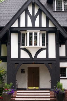 a black and white house with an arched doorway