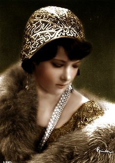 a woman in a fur coat and hat with pearls on her head, wearing a diamond - encrusted necklace