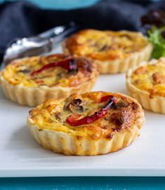 mini quiche pies on a white serving tray