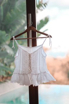 Beautiful Coachella white gauze tank top. A laid back bohemian style with cotton lace and frills. Front tie with cotton ties. Made of double cotton gauze cheese cloth. Size fits up to size 10. Preorder for 4 weeks. Shipped with DHL Express worldwide in 1 week duration. Summer Cotton Lace Top, White Tie Back Camisole For Summer, White Bohemian Top With Ruffles, White Cotton Lace Sleeveless Top, White Sleeveless Cotton Lace Top, Bohemian Ruffled Lace Top For Summer, Bohemian Lace Top With Ruffles For Summer, Bohemian Lace Tops With Spaghetti Straps, Bohemian Sleeveless Top With Tassel Ties