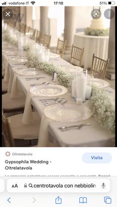 a long table with white plates and silverware on it is set up for a baby's breath wedding