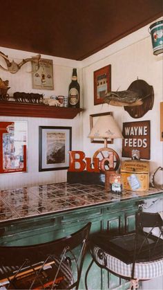 an old fashioned bar with lots of signs on the wall and pictures hanging above it