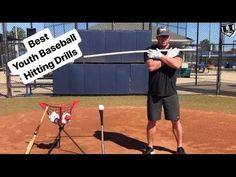 a man holding a baseball bat on top of a field next to a sign that says best youth baseball hitting drills