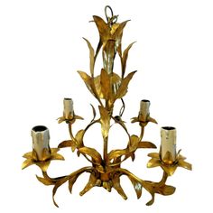 a golden chandelier with six candles on it