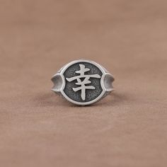 Japanese Kanji Sachi Engraved Statement Ring, Symbol of Happiness Signet Ring,  925 Sterling Silver Handmade Biker Ring for Him, Cool Rings ✅ With its eye-catching design and intricate detailing, this ring is sure to draw eyes, making it a perfect conversation starter. ✅ Whether you're looking for a unique piece of jewelry to add to your collection or a gift for a special someone, this ring is sure to be a treasured item. * Crafted from 925 sterling silver  * Intricate and elegant ring * Eye-cat Adjustable Symbolic Carved Rings, Symbolic Carved Sterling Silver Rings, Symbolic Engraved Carved Ring As Gift, Symbolic Carved Engraved Ring As Gift, Symbolic Engraved Carved Ring For Gift, Carved Sterling Silver Signet Ring, Symbolic Round Sterling Silver Engraved Ring, Symbolic Sterling Silver Stamped Rings, Symbolic Stamped Sterling Silver Rings