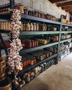 shelves filled with lots of different types of spices and jars in a store or restaurant