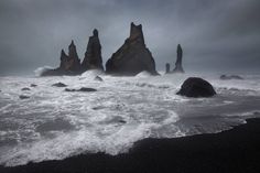 some rocks in the water and waves crashing on them