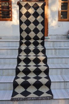 a black and white rug sitting on top of some steps