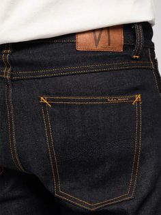 Slim fit jeans with a tapered leg made in organic comfort stretch denim. These jeans are made from 13.5 oz Turkish selvage denim with clear, diagonal, twill lines, a slight warp yarn slub, and a deep, dark, indigo hue. Where wearing exposes the denim for abrasion, a flat surface with clear twill lines will be rendered. On the other hand, the unabraded areas will pucker and render a nice grainy, salt 'n pepper surface. This contrast between surface structures is one of the fabric's greatest trait Selvage Denim, Dark Indigo, Nudie Jeans, Engineered Garments, Khaki Green, Contrast Stitch, Mens Denim, Jeans Slim, Slim Fit Jeans