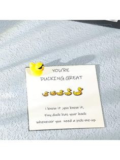 a note with rubber ducks attached to it