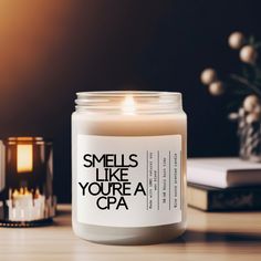 a candle that reads smells like you're a capa next to some candles