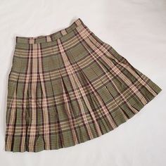 Jonathan green plaid pleated a line uniform tennis skirt  size medium (determined by measurements, no size tag) Please look at Measurements, brand sizes can vary immensely Measurements Waist 33 Hips 42 Length24.5 Skirt circumference 110 Fabric is probably cotton All pre owned clothing is laundered before being shipped a classic green tan and yellow  plaid pleated skirt for a preppy uniform regency mod 60s or sporty look. very well made and excellent quality Skirt is pre owned and in excellent co Preppy Uniform, Jonathan Green, Mod 60s, Plaid Pleated Skirt, Yellow Plaid, Tennis Skirt, Sporty Look, Green Plaid, Size Tag