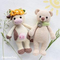 two crocheted stuffed animals sitting next to each other