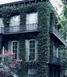 an old house covered in vines and flowers