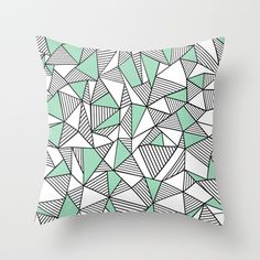 a blue and white pillow with an abstract design on the front, featuring triangular shapes