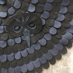 an owl made out of black paper with scissors