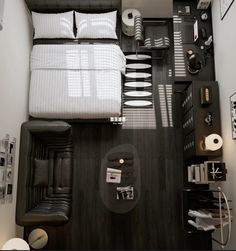 an overhead view of a bed and desk in a small room