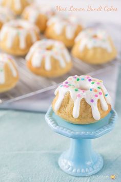 a cake on a blue plate with icing and sprinkles