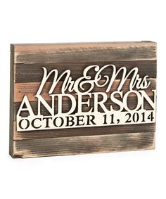 a wooden sign with the words mr and mrs on it, in white lettering that reads