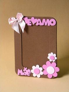 a brown box with pink and white flowers on the front, decorated with a bow