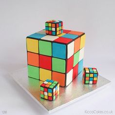 a cake made to look like a rubik cube with three smaller blocks on top