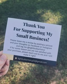 a person holding up a sign that says, thank you for supporting my small business