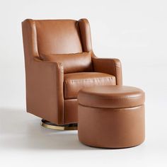 a brown leather chair and ottoman sitting next to each other