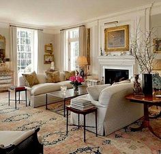 a living room filled with lots of furniture and decor on top of carpeted flooring