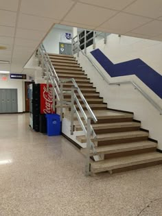 there is a set of stairs leading up to the second floor in this school building