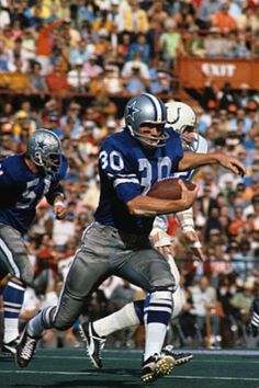 an autographed photograph of a football player running with the ball in his hand