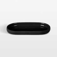 a black oval tray on a white background