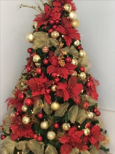 a christmas tree decorated with red and gold ornaments