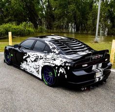 a black sports car with white paint on it