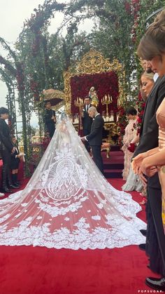 the bride is getting ready to walk down the aisle in her wedding dress and veil