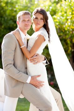 a bride and groom pose for a wedding photo