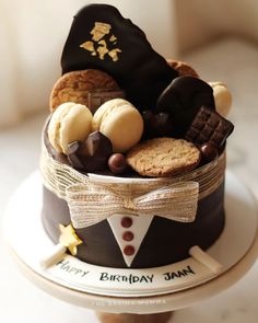 a birthday cake decorated with cookies and chocolates